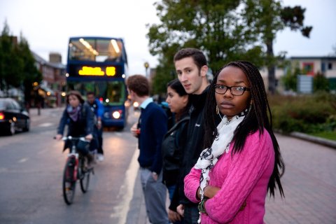 Passengers at a bus stop Photo of passengers at a bus stop