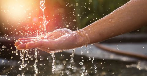 Hand catching dripping water