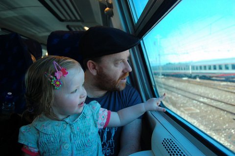Parent and child on train Photo of parent and child on train