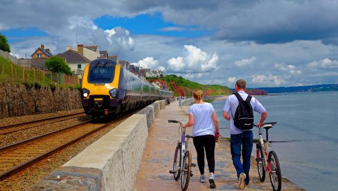 Walking with bikes by a train Walking with bikes by a train