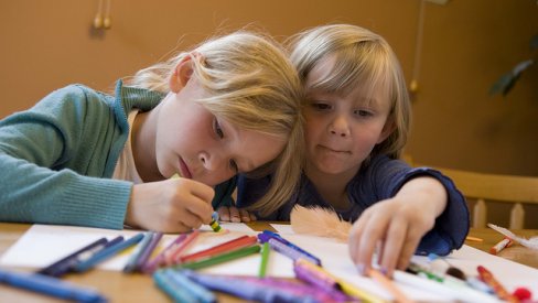Photo of children drawing with crayons
