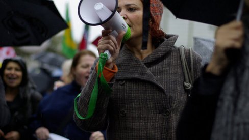 Woman with megaphone in a crowd