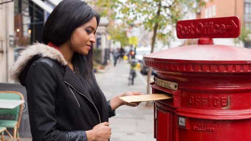 Woman posting a letter